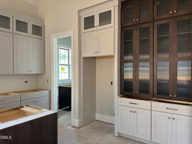 a view of an empty room with a fireplace and a window
