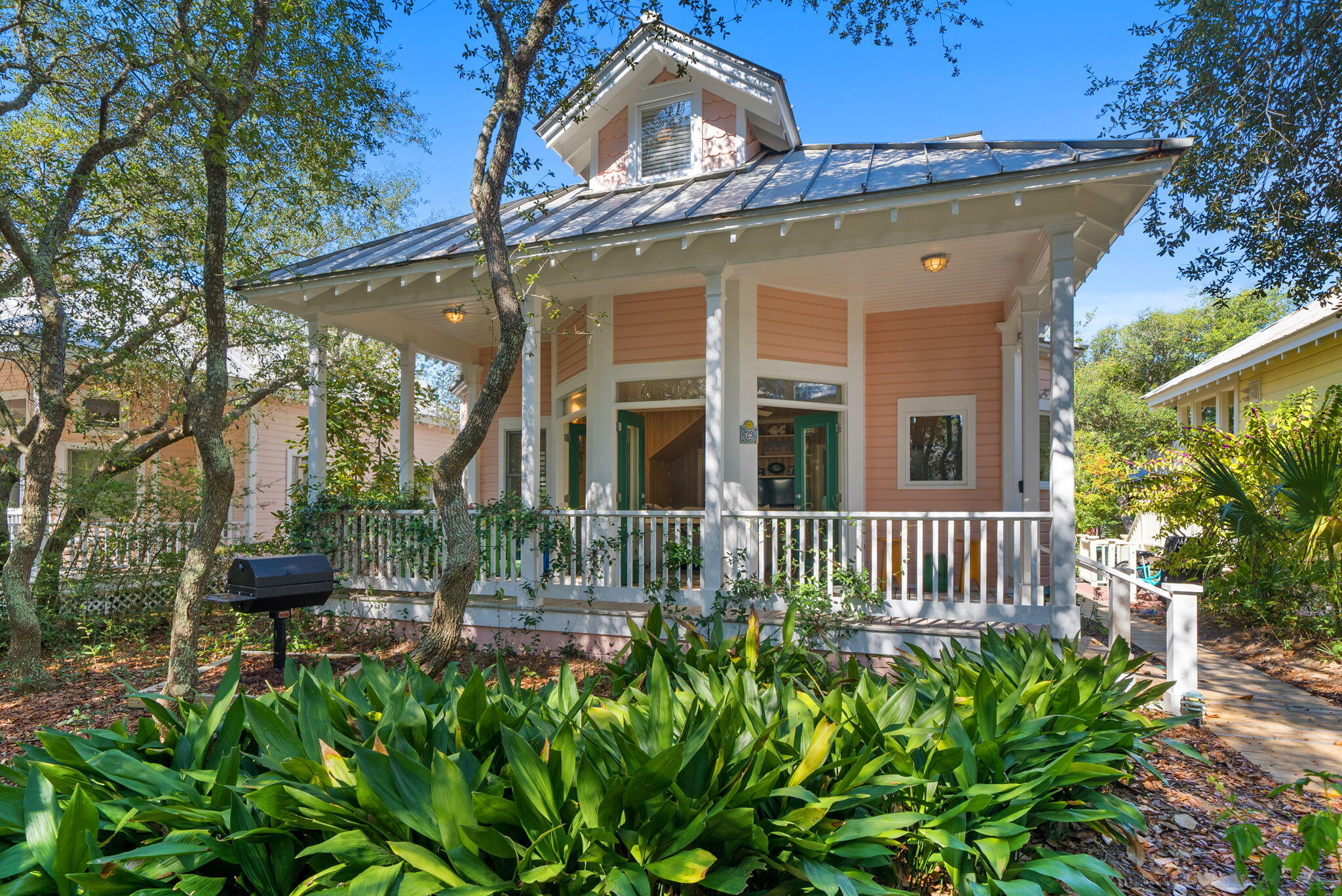 a front view of a house with a garden