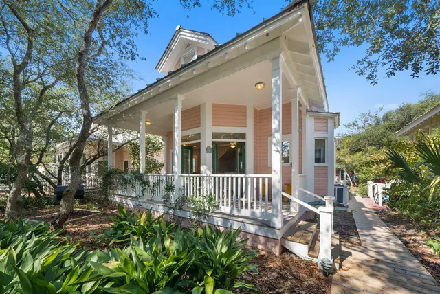 an aerial view of ocean and residential houses with outdoor space