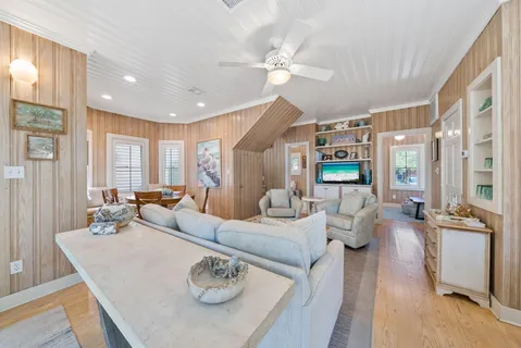 a view of a dining room with furniture a livingroom and chandelier