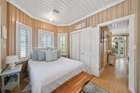 a bedroom with furniture and a large window