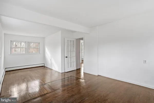 an empty room with windows and closet