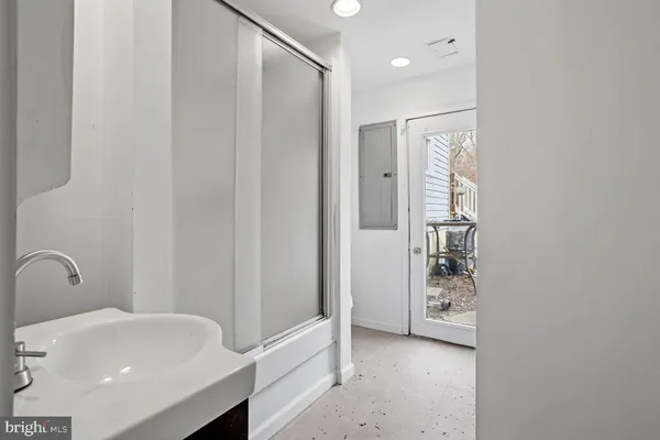a bathroom with a tub sink and mirror