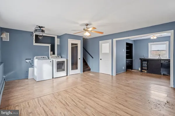 a view of a kitchen with a sink a kitchen counter space and a stove top oven
