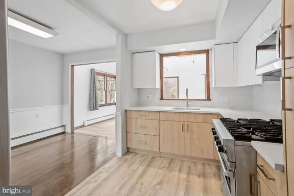 a kitchen with granite countertop white cabinets and white appliances