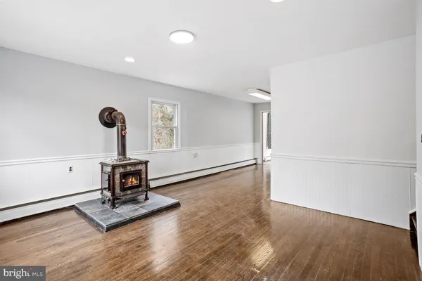 a view of a room with wooden floor and windows