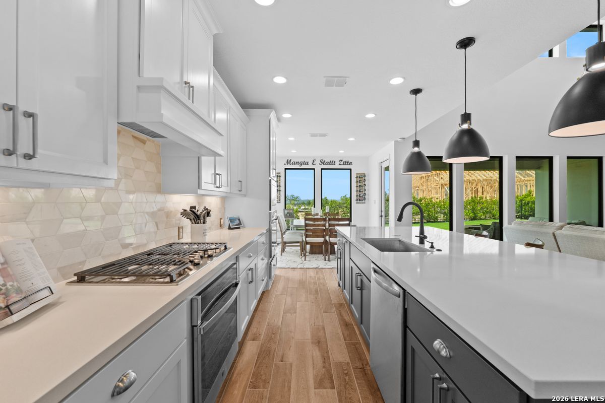 402 Fandango Boerne, TX 78006 - Photo 11 of 34 a kitchen with stainless steel appliances a stove a sink a counter space and a window