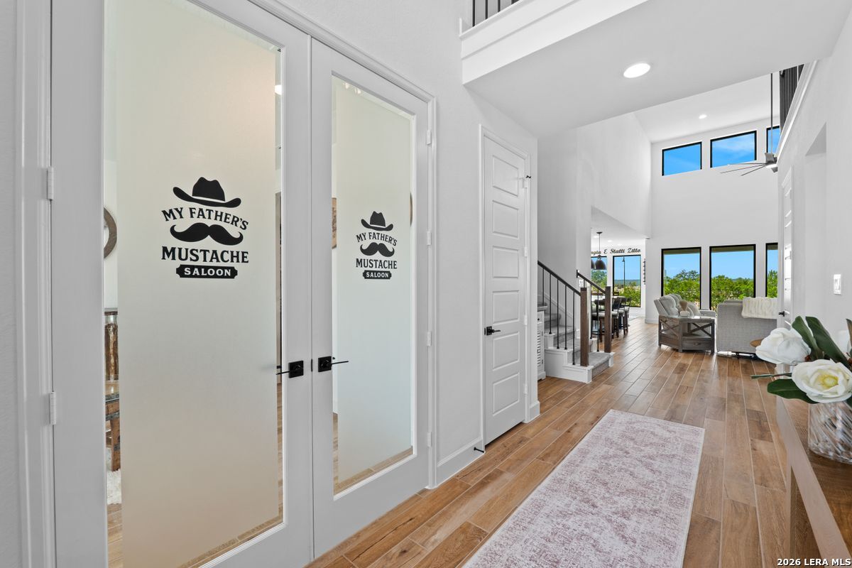 402 Fandango Boerne, TX 78006 - Photo 13 of 34 a view of a hallway with wooden floor and windows