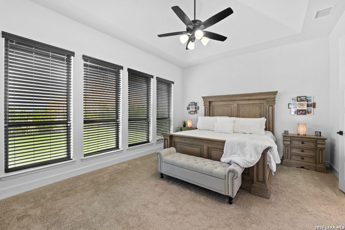 402 Fandango Boerne, TX 78006 - Photo 15 of 34 a spacious bedroom with a bed and a large window