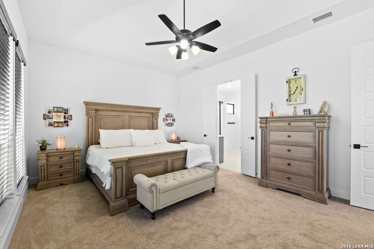 402 Fandango Boerne, TX 78006 - Photo 16 of 34 a bedroom with a bed and ceiling fan