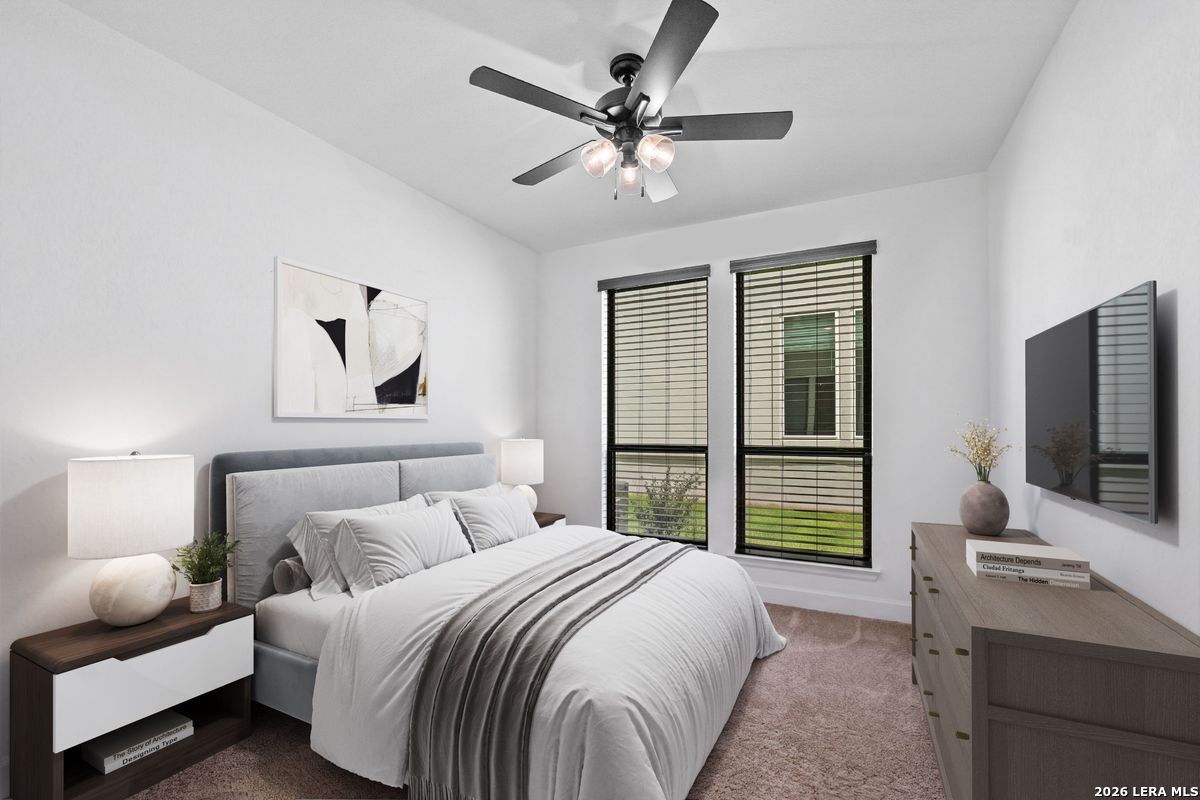 402 Fandango Boerne, TX 78006 - Photo 19 of 34 a bedroom with a bed window and a flat screen tv