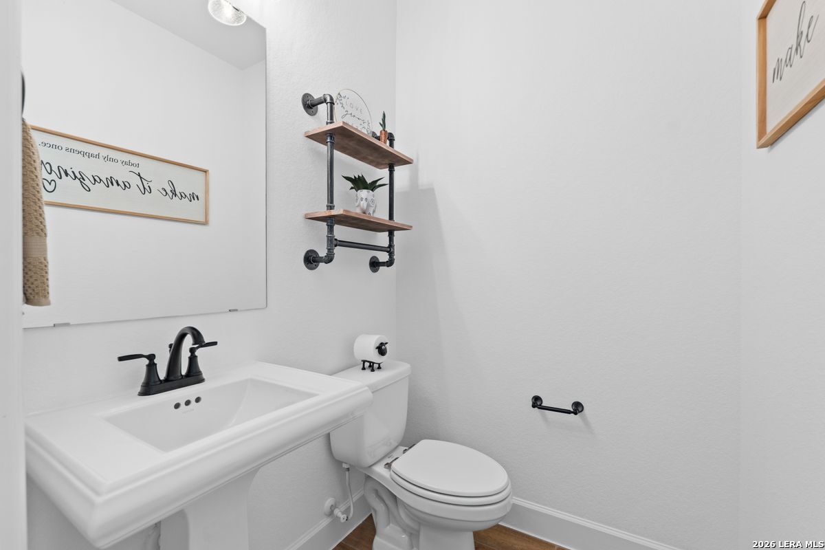 402 Fandango Boerne, TX 78006 - Photo 26 of 34 a white toilet sitting next to a bathroom sink