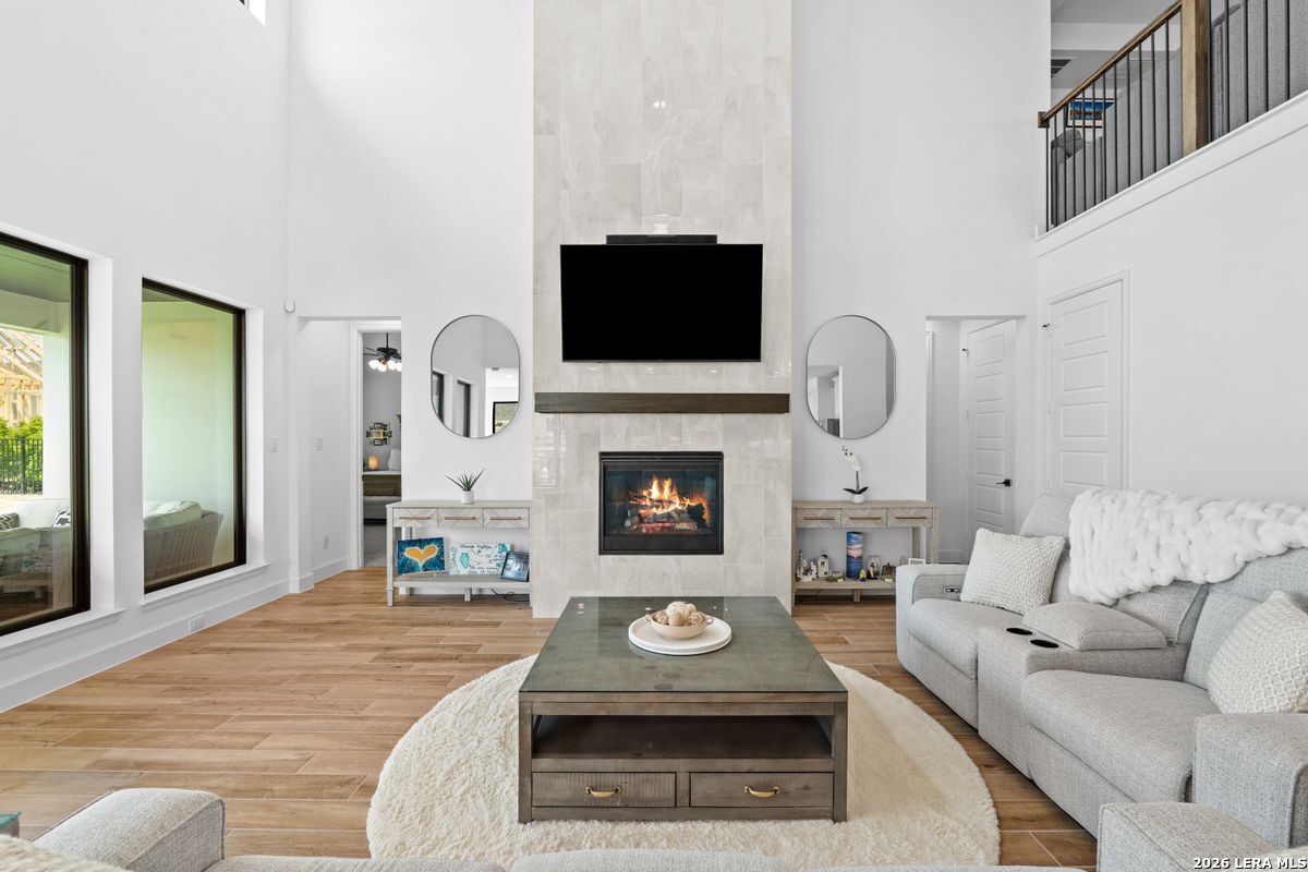 402 Fandango Boerne, TX 78006 - Photo 5 of 34 a living room with furniture a flat screen tv and a fireplace