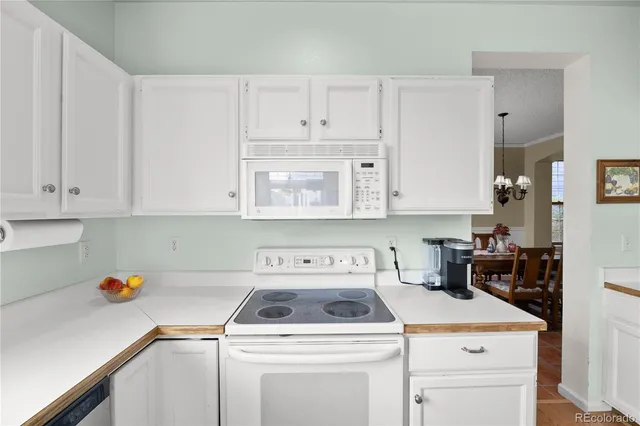 a kitchen with a sink a stove and cabinets