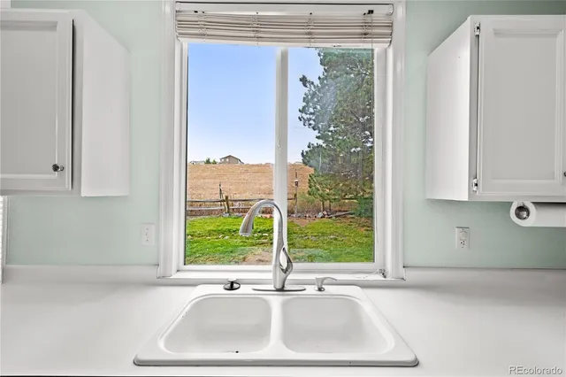 a bathroom with a sink and a large window