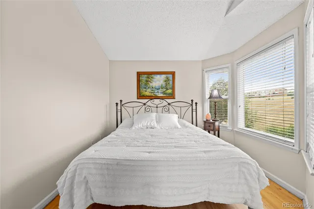 a large bed sitting in a bedroom next to a window