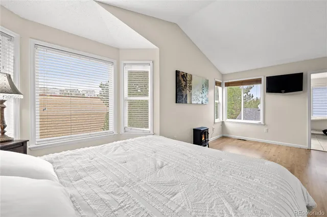 a bedroom with a large bed and a window