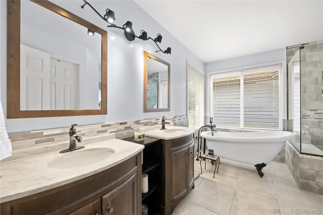 a bathroom with a tub sink and mirror