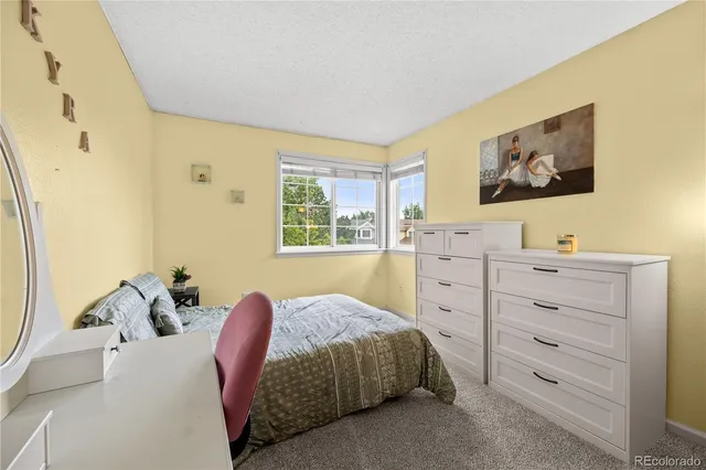 a view of a patio with chair and table and chairs and potted plants