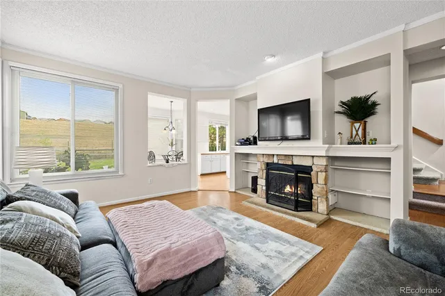 a living room with furniture fireplace and flat screen tv