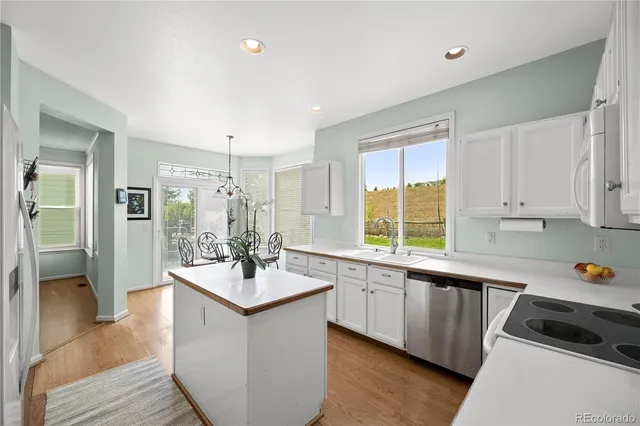 a kitchen with a sink stove and cabinets