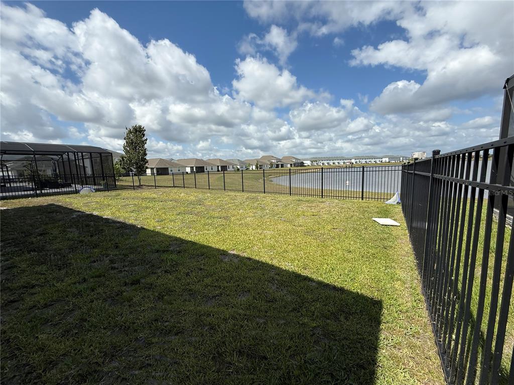2926 Wordsmith Road Kissimmee, FL 34746 - Photo 40 of 42 a view of a swimming pool with an outdoor seating and a yard