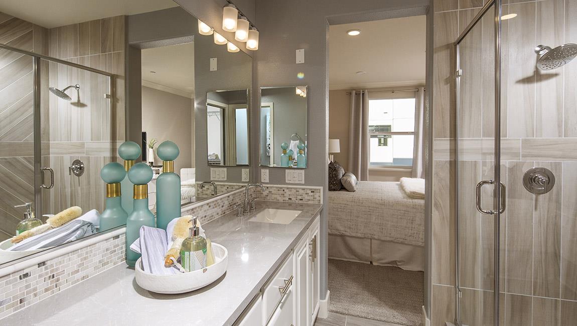 1653 Centre Pointe Drive Milpitas, CA 95035 - Photo 13 of 28 a bathroom with a sink a light fixture and glass door