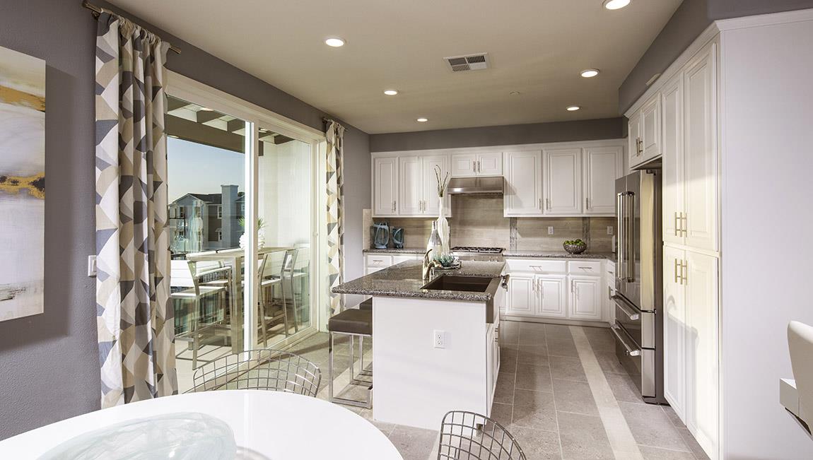 1653 Centre Pointe Drive Milpitas, CA 95035 - Photo 4 of 28 a kitchen with white cabinets and stainless steel appliances