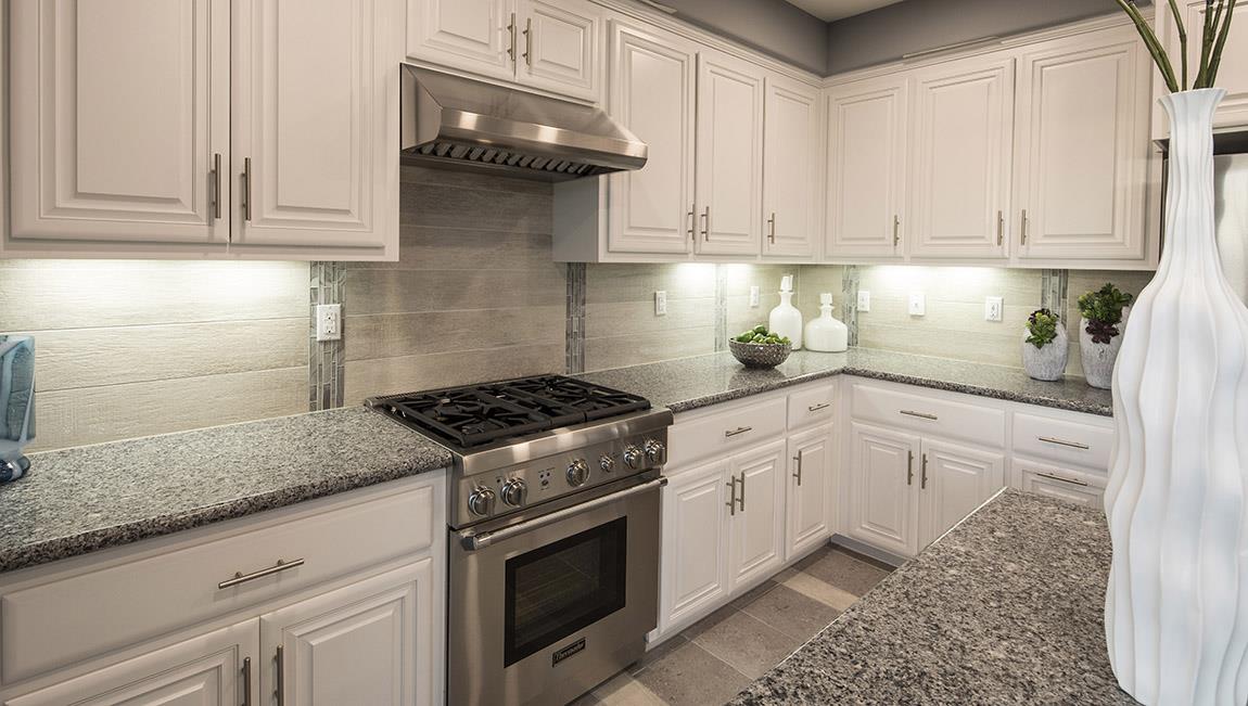 1653 Centre Pointe Drive Milpitas, CA 95035 - Photo 5 of 28 a kitchen with stainless steel appliances granite countertop a stove a sink and white cabinets