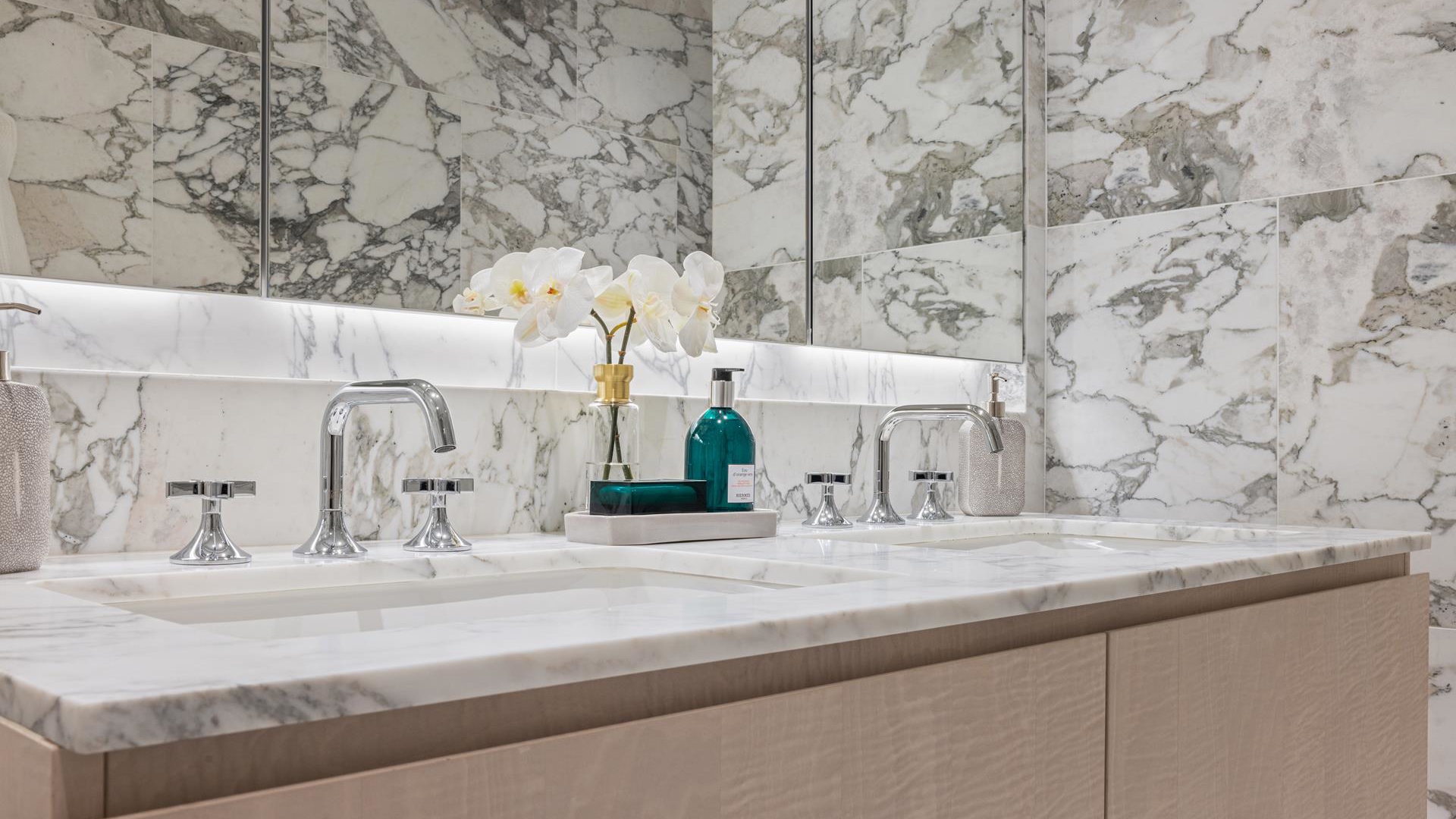201 East 74th Street, Unit 6A Manhattan, NY 10021 - Photo 4 of 21 a bathroom with a granite countertop sink and a mirror