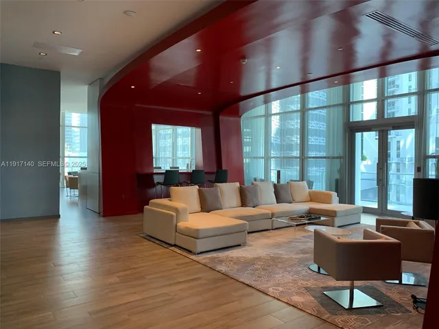 a living room with furniture and a potted plant