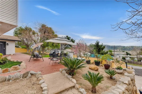 a view of house with backyard