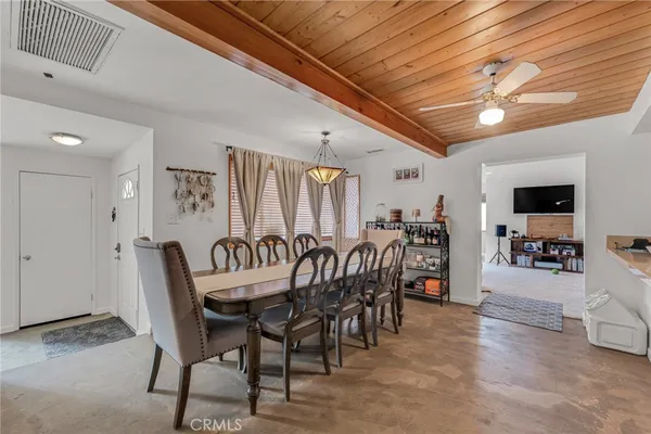 a view of a dining room with furniture and a chandelier