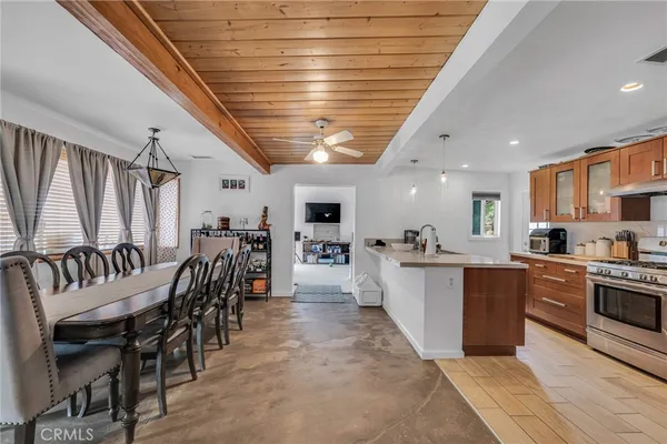 a kitchen with stainless steel appliances granite countertop a sink a stove and a refrigerator