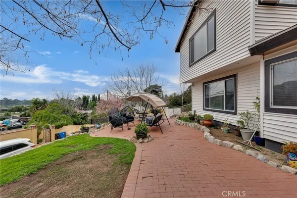 a view of a backyard with sitting area