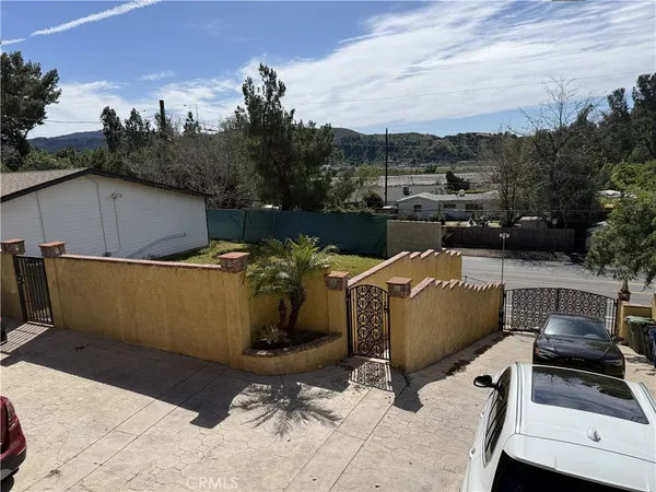 a view of a house with a yard and sitting area