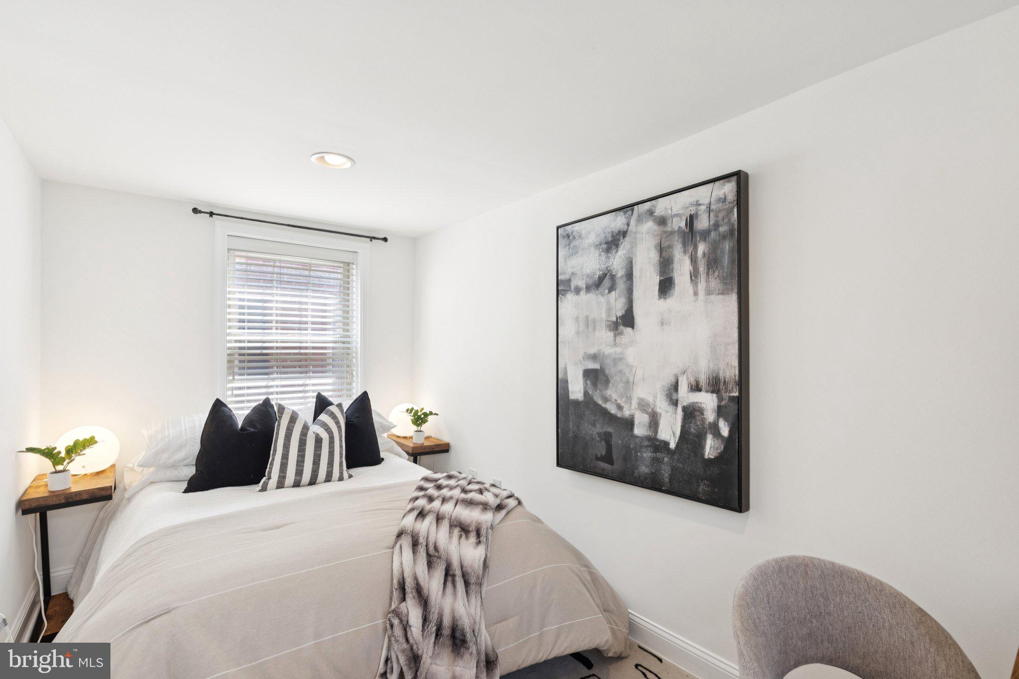 525 Fitzwater Street, Unit 4 Philadelphia, PA 19147 - Photo 11 of 20 a bedroom with a bed and painting on the wall