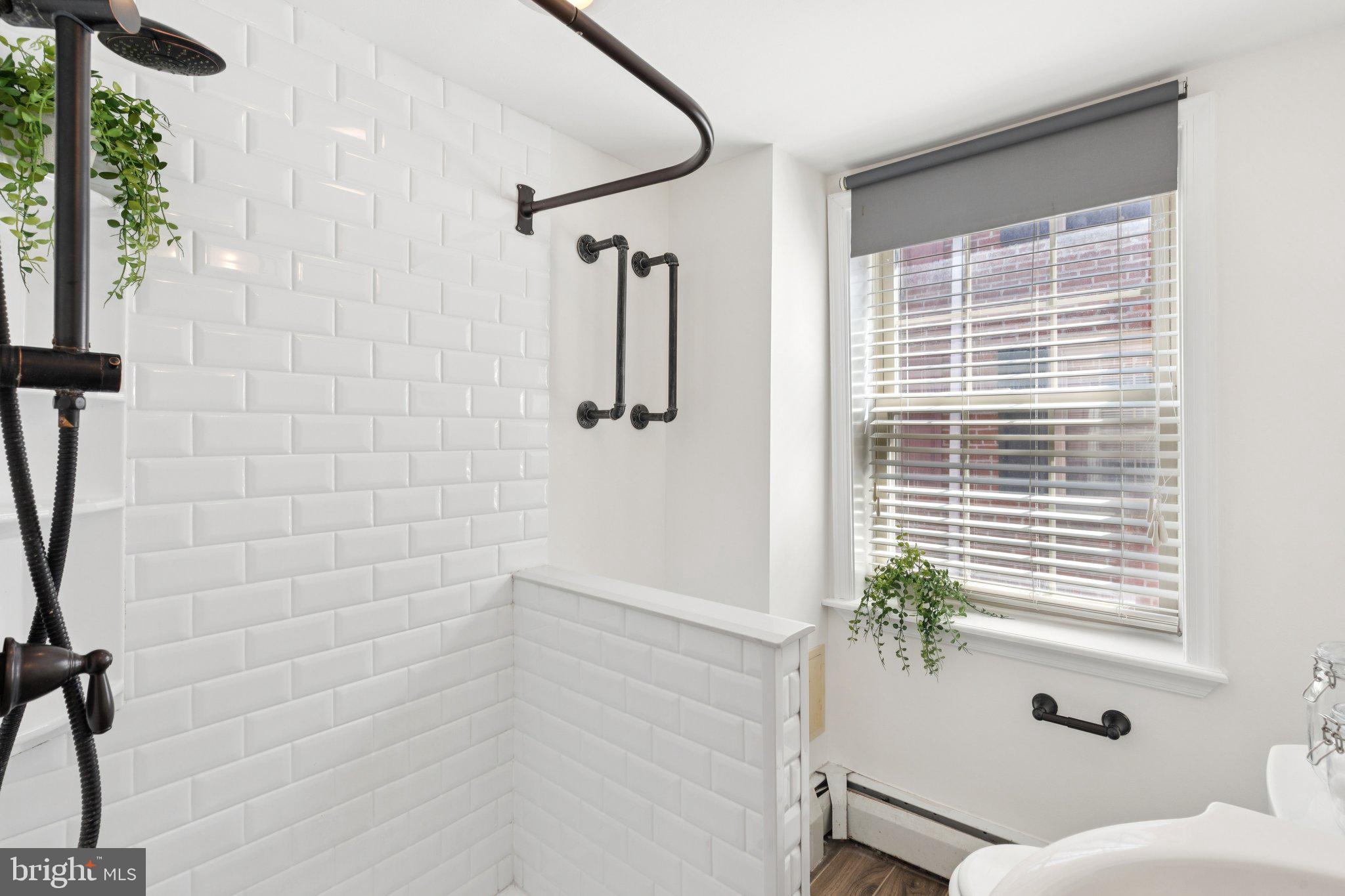 525 Fitzwater Street, Unit 4 Philadelphia, PA 19147 - Photo 14 of 20 a bathroom with a shower and a window