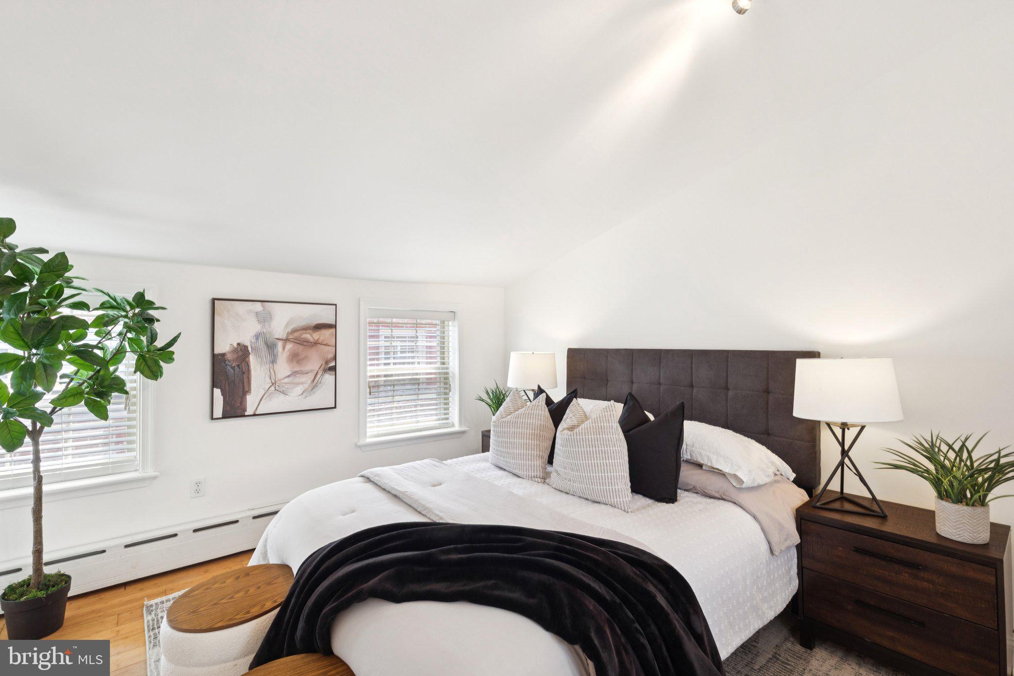 525 Fitzwater Street, Unit 4 Philadelphia, PA 19147 - Photo 15 of 20 a bedroom with a bed and a potted plant