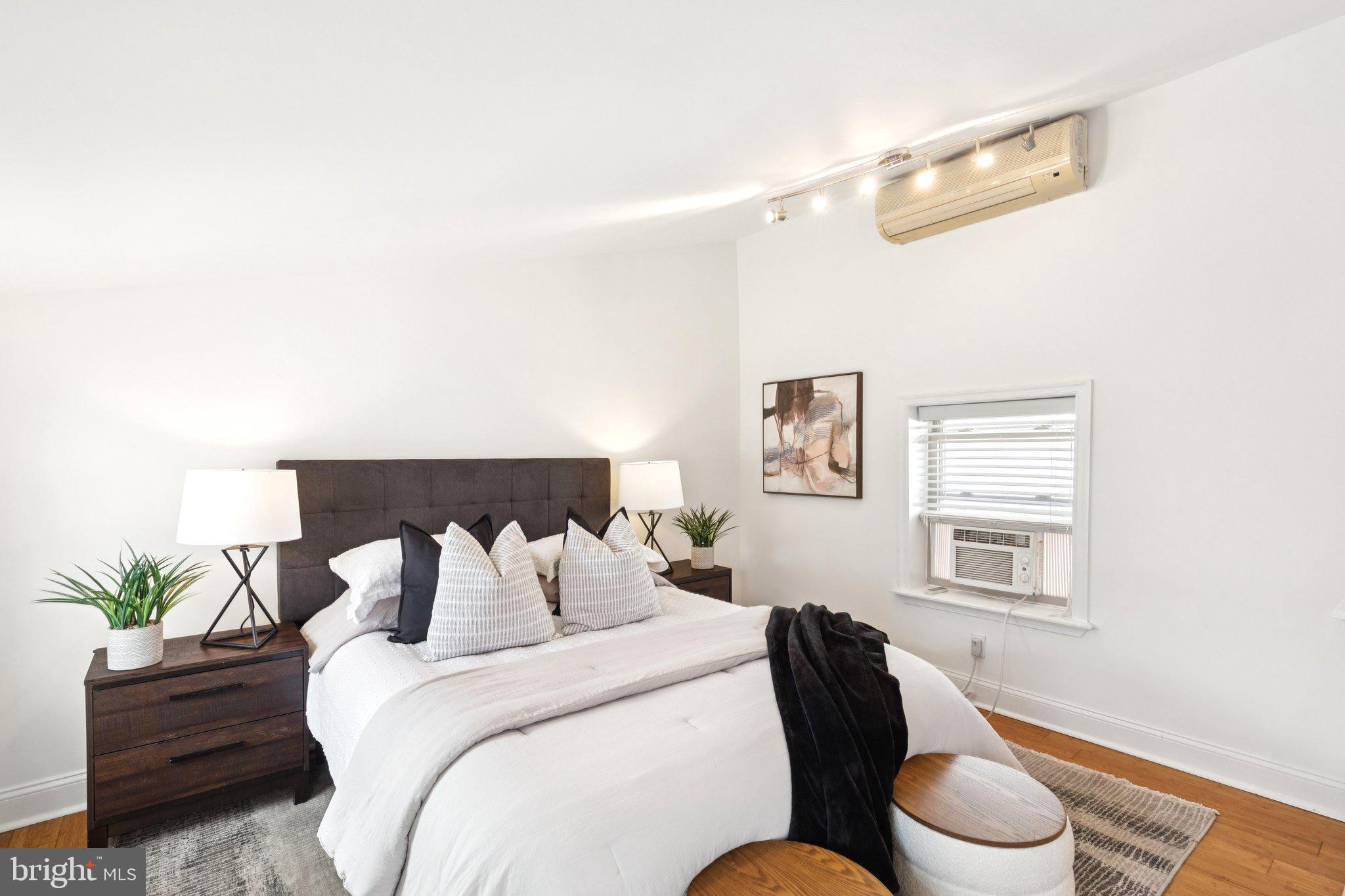 525 Fitzwater Street, Unit 4 Philadelphia, PA 19147 - Photo 16 of 20 a bedroom with a bed and a lamp with the potted plant