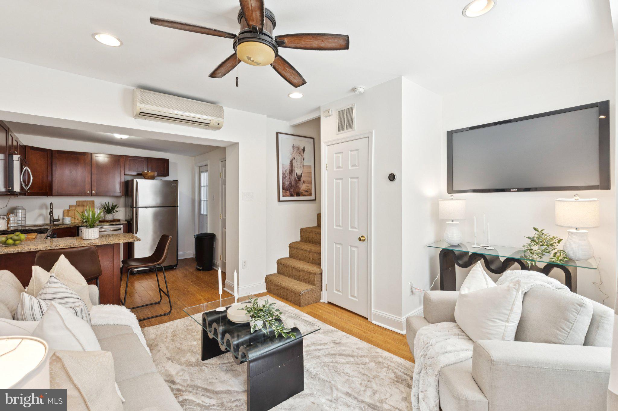 525 Fitzwater Street, Unit 4 Philadelphia, PA 19147 - Photo 3 of 20 a living room with furniture and a flat screen tv