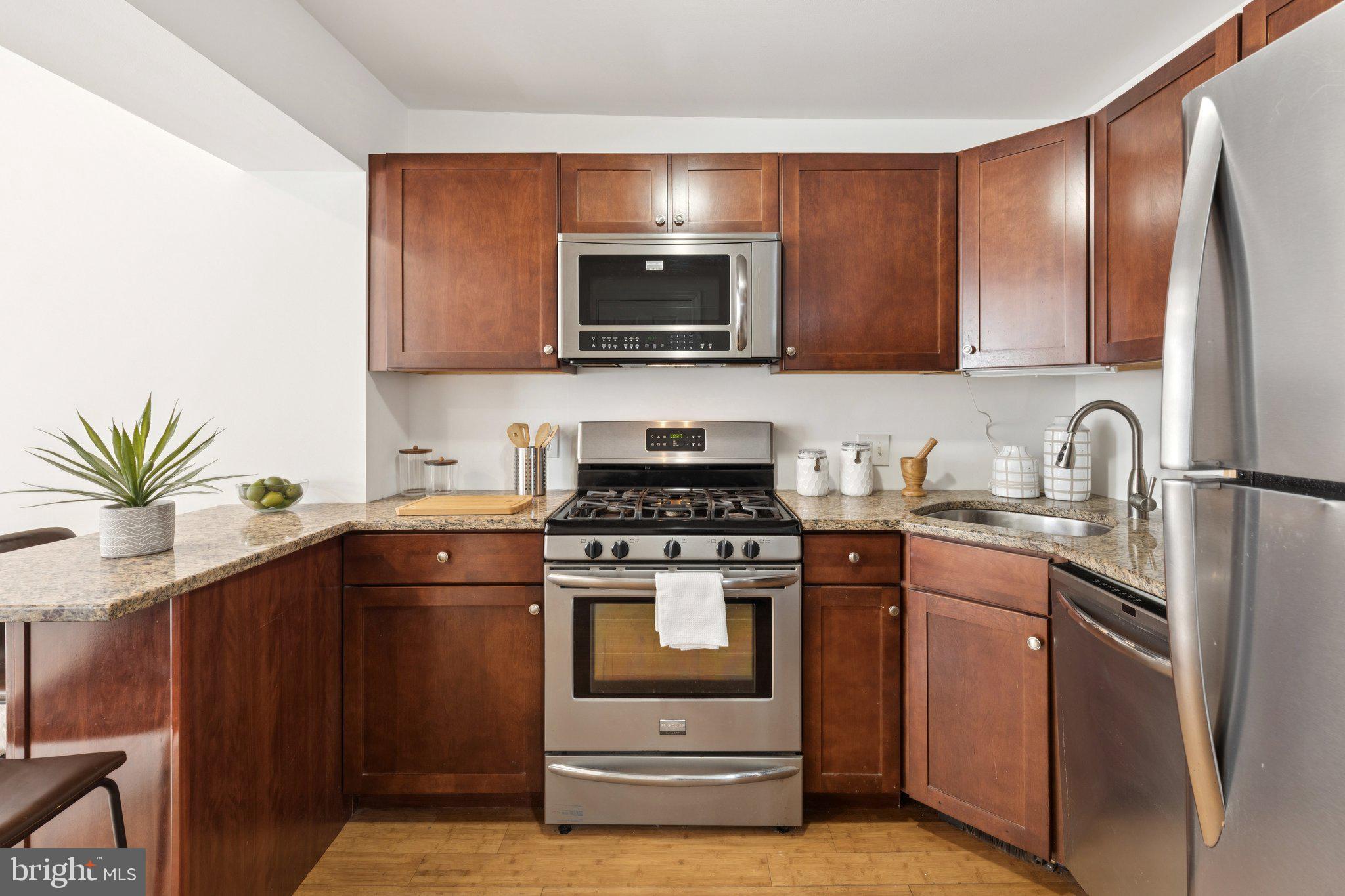 525 Fitzwater Street, Unit 4 Philadelphia, PA 19147 - Photo 8 of 20 a kitchen with stainless steel appliances a stove a sink and a microwave
