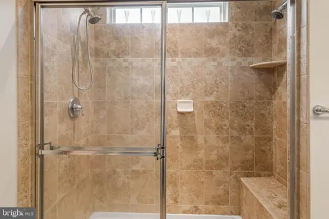 a bathroom with a glass shower door
