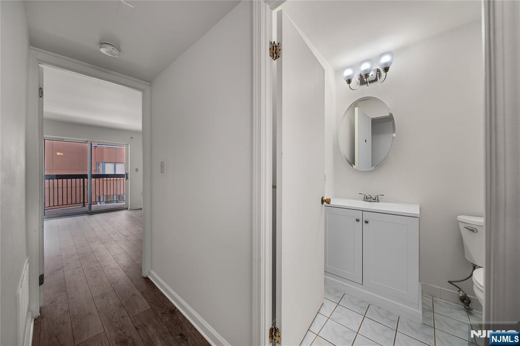 402 Chase Court, Unit 402 Edgewater, NJ 07020 - Photo 11 of 21 a bathroom with a sink and mirror
