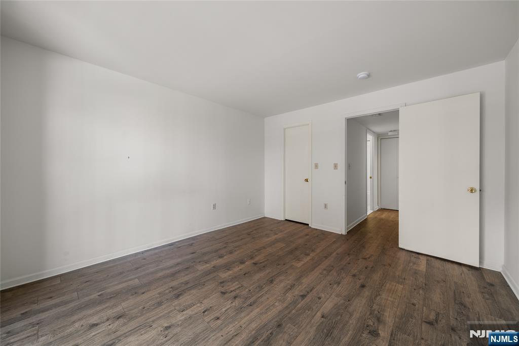 402 Chase Court, Unit 402 Edgewater, NJ 07020 - Photo 15 of 21 a view of an empty room with wooden floor