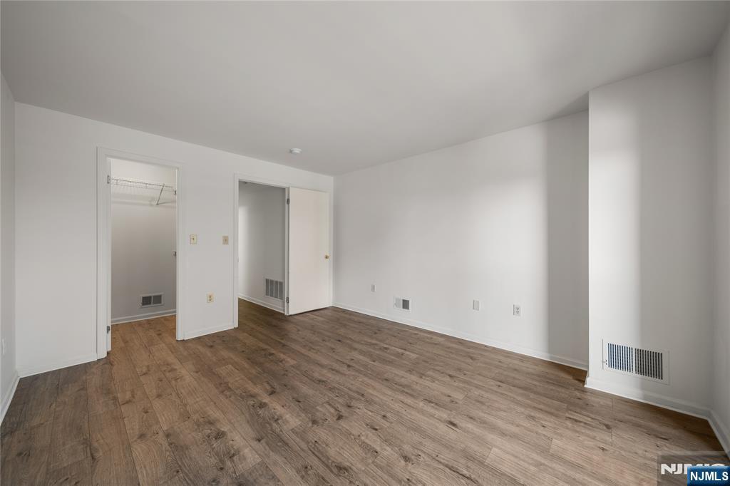 402 Chase Court, Unit 402 Edgewater, NJ 07020 - Photo 16 of 21 a view of an empty room with wooden floor