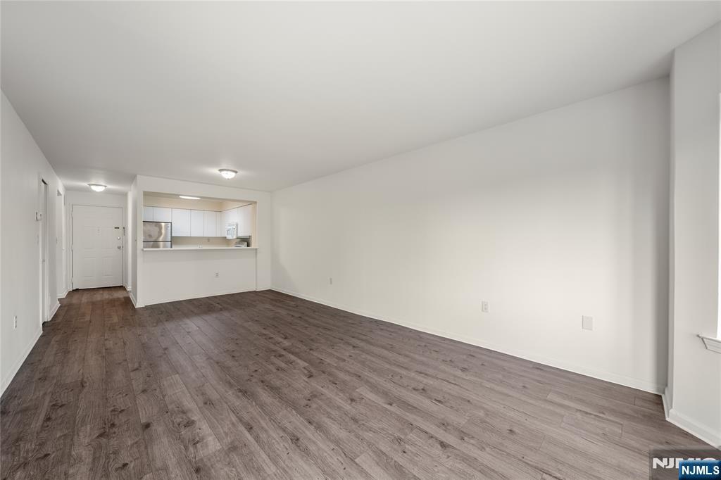 402 Chase Court, Unit 402 Edgewater, NJ 07020 - Photo 8 of 21 a view of a kitchen with wooden floor and a sink