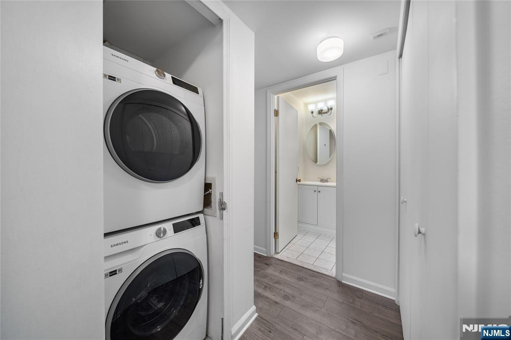 402 Chase Court, Unit 402 Edgewater, NJ 07020 - Photo 10 of 21 a view of a hallway with washer and dryer
