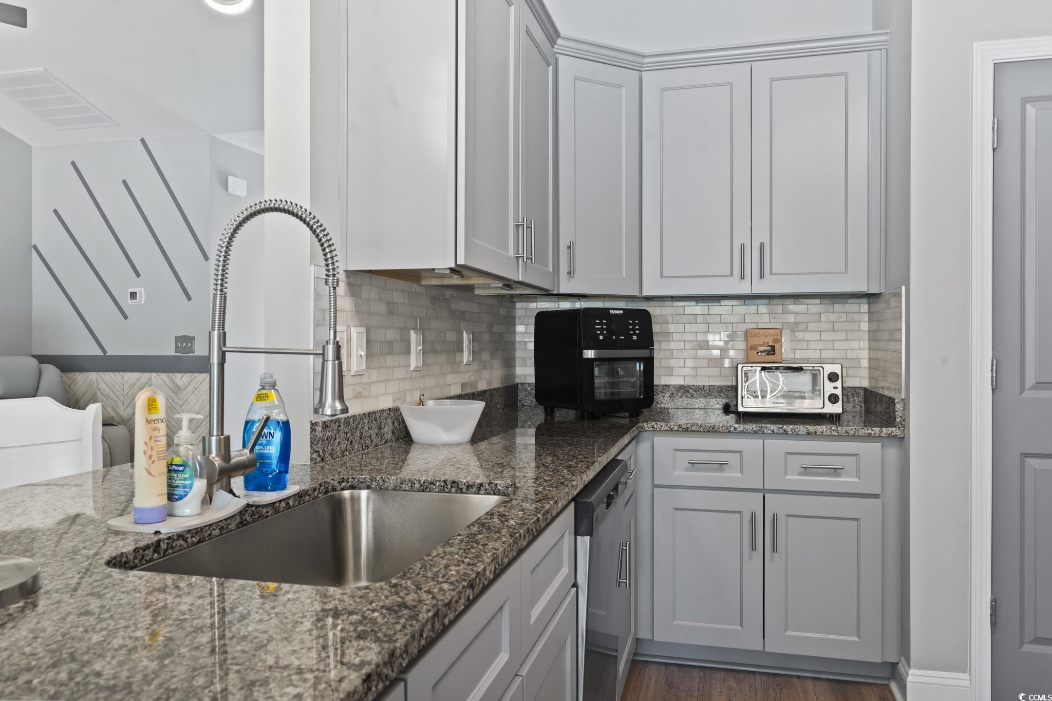 804 Twickenham Loop Longs, SC 29568 - Photo 12 of 26 Kitchen with backsplash, dark stone counters, stainless steel dishwasher, dark wood-style floors, and gray cabinets