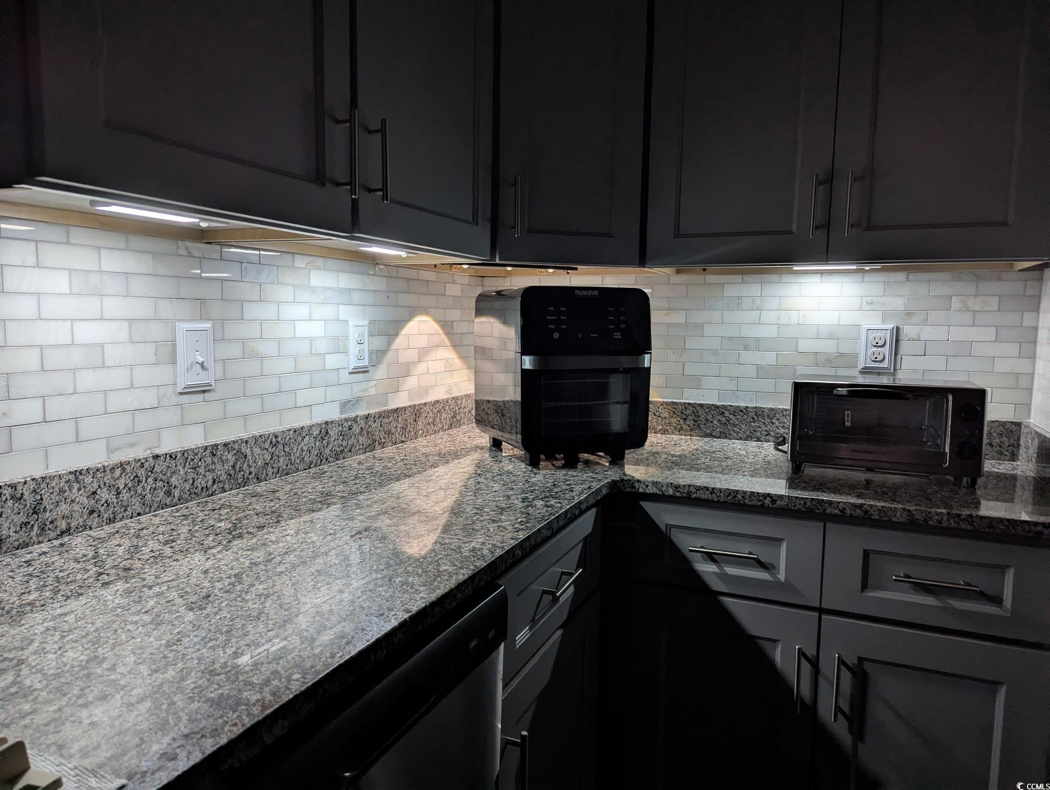 804 Twickenham Loop Longs, SC 29568 - Photo 14 of 26 Kitchen featuring dark stone counters, tasteful backsplash, gray cabinets, and dark cabinetry